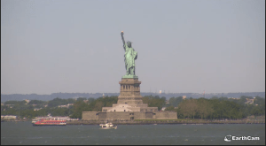 Small boat sailing past the Statue of Liberty