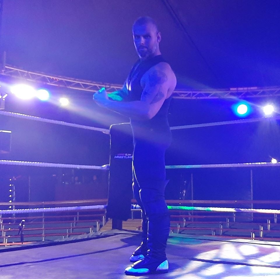 Wrestler Troy Merrick flexing in the ring
