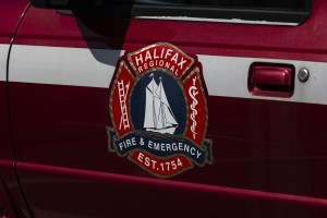 A logo for the Halifax fire service on the side of a red and white vehicle.