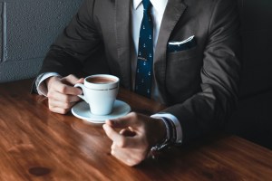 Man in suit with cup of coffee