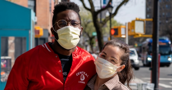 Couple on the street wearing masks.
