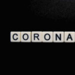 Coronavirus written in white tiles on a black background