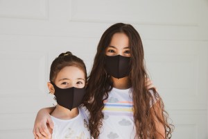 Two young girls wearing blacks masks