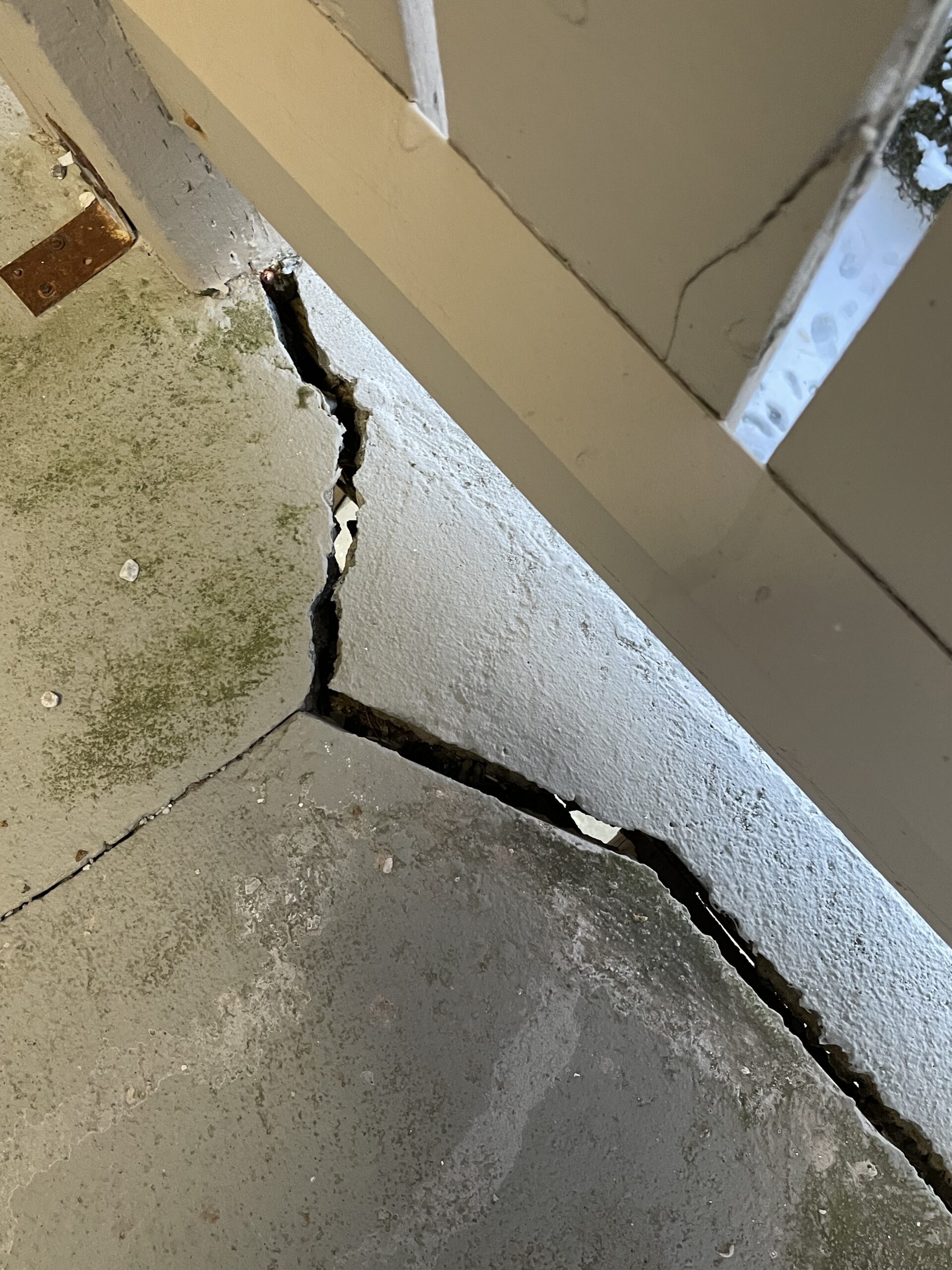 A crack in the cement of a balcony
