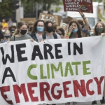 A climate emergency protest group with a large banner