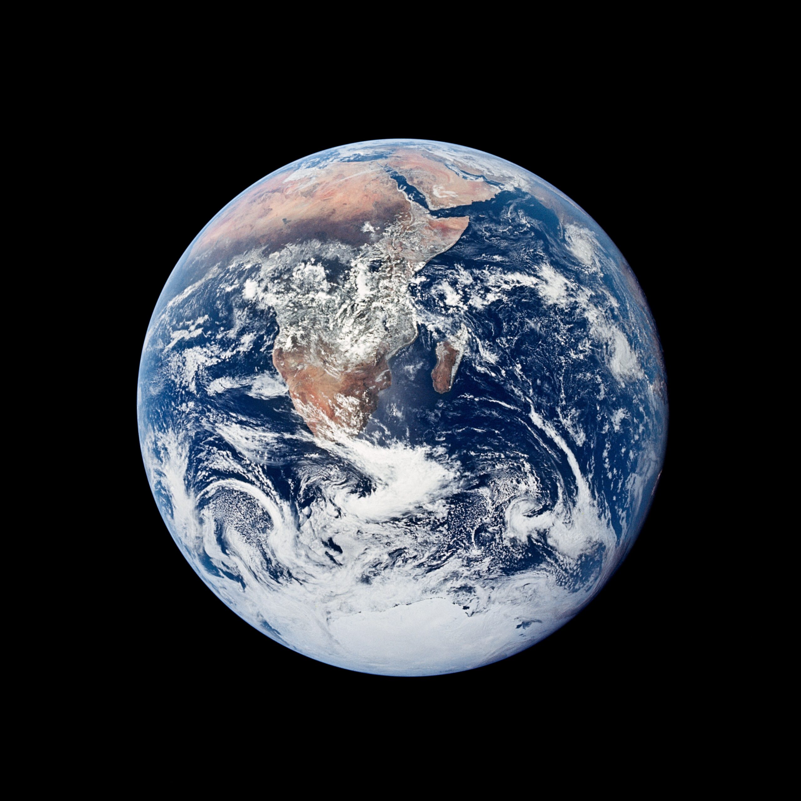 The Earth in full profile from space, resembling a blue marble.