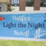 A blue banner which says Halifax light the Night Kickoff